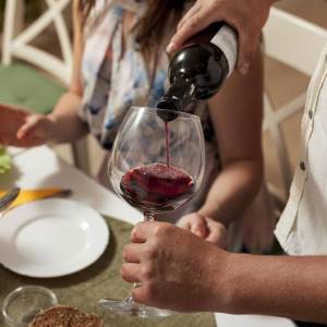 side-view-man-pouring-wine-glass-dinner-table-min_original